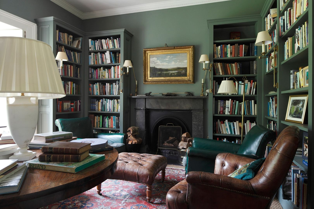 Vintage home library with leather armchairs and ornate bookcases