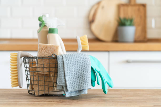 Cleaning supplies in a wire basket on a kitchen counter, ready for holiday preparation.